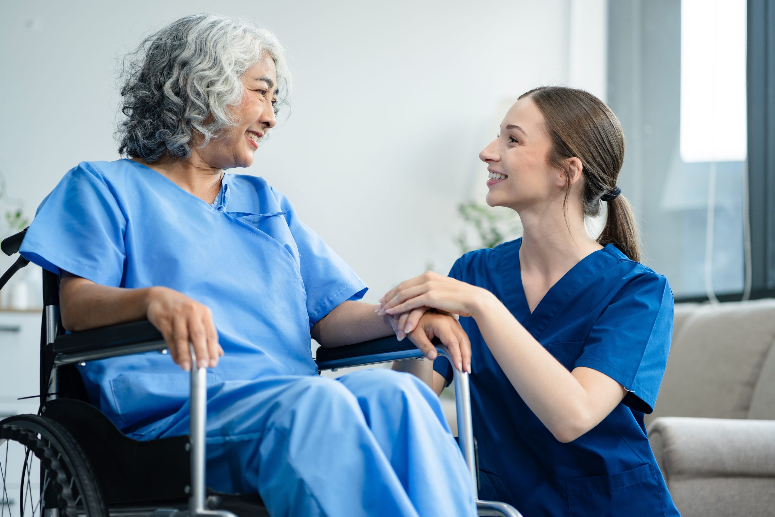 Elderly care concept. Portrait of nurse and her senior client on wheelchair.